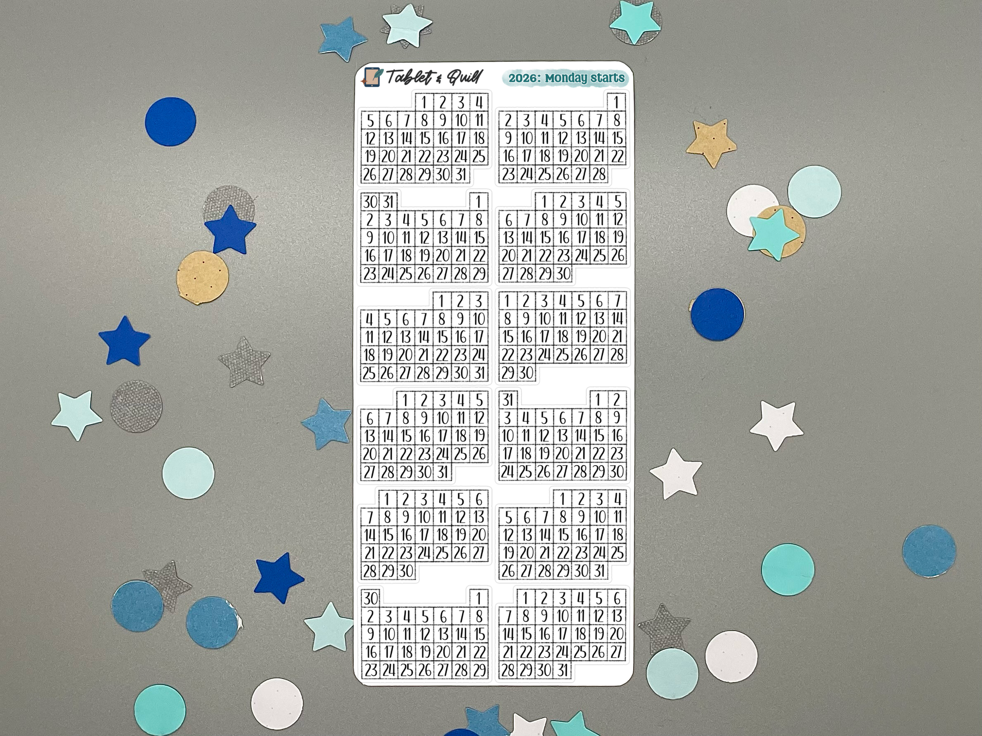 Sheet of pre-printed 2026 Monday start calendars on a gray background with decorative stars.