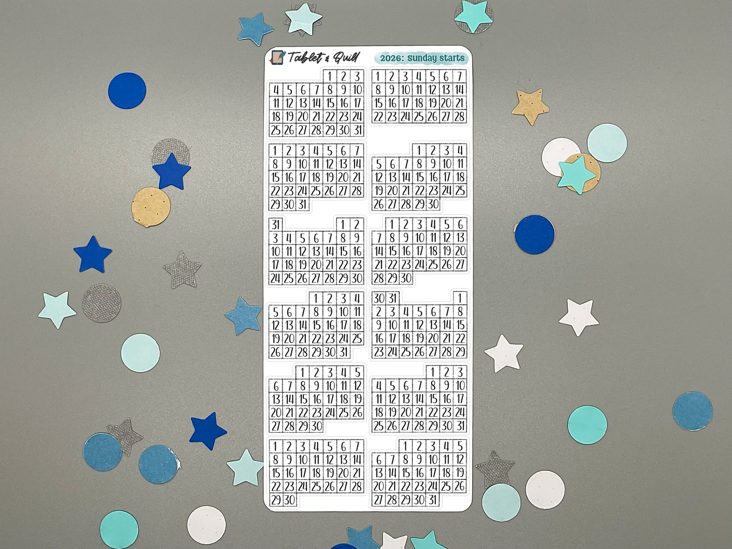 Sheet of pre-printed 2026 Sunday start calendars on a gray background with decorative stars.