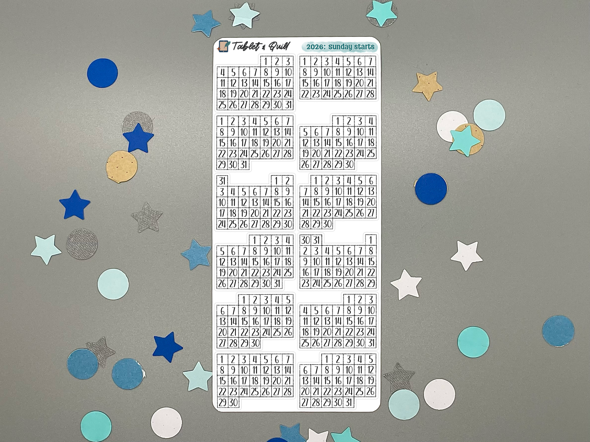 Sheet of pre-printed 2026 Sunday start calendars on a gray background with decorative stars.