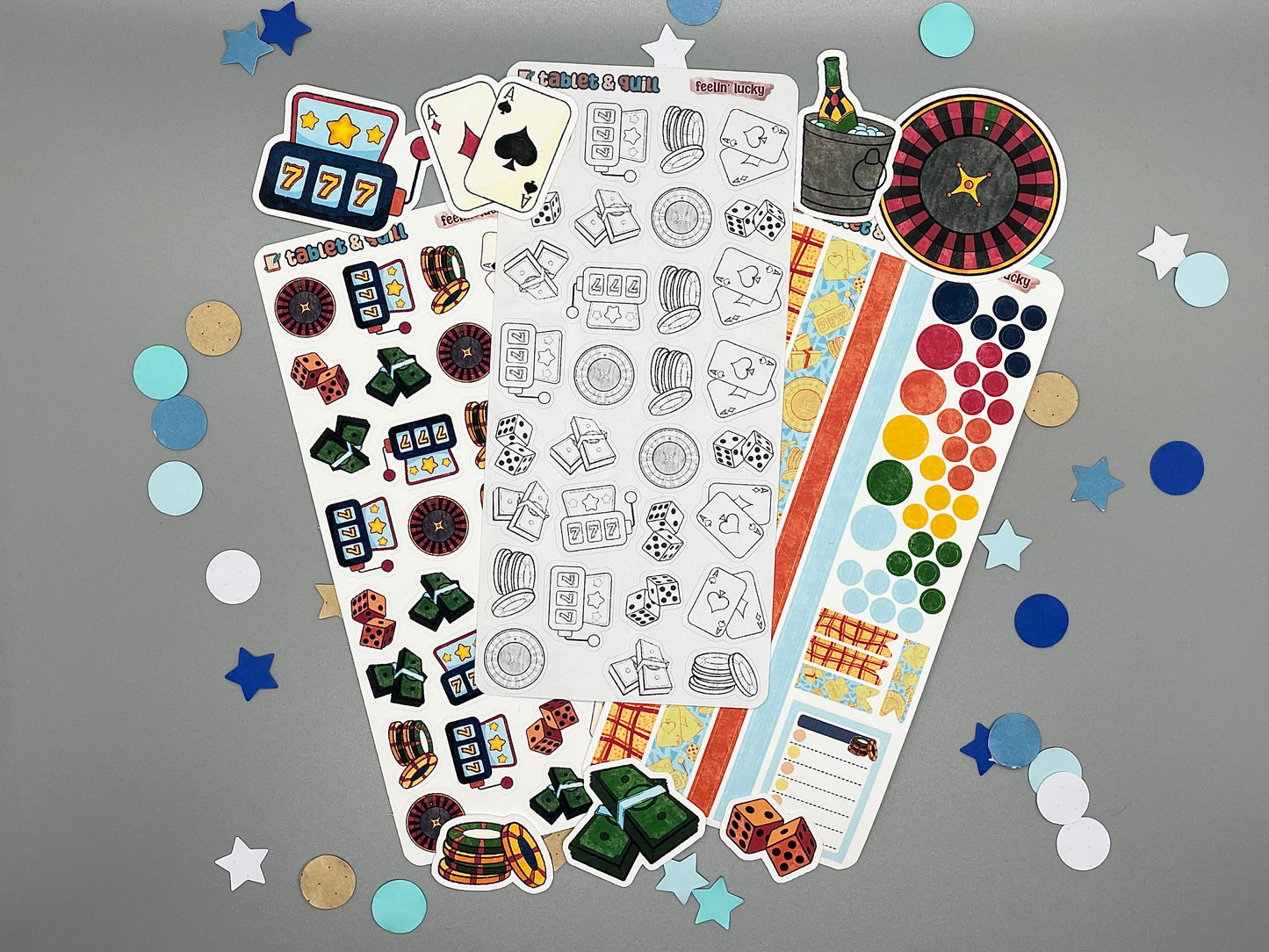 An overview image of casino themed stickers, including a color sticker sheet, a colorable sticker sheet, a decorative sticker sheet, and die cut sticker flakes.