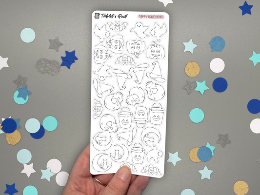 Sheet of Halloween themed stickers held over a gray background with colorful confetti.