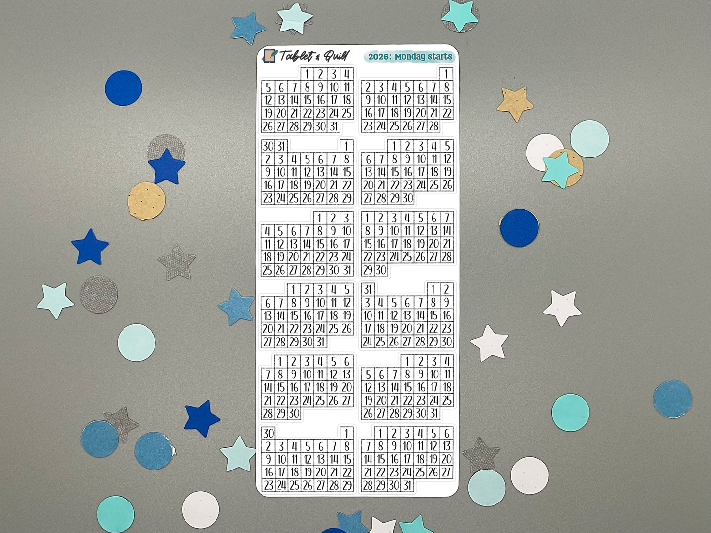 Sheet of pre-printed 2026 Monday start calendars on a gray background with decorative stars.