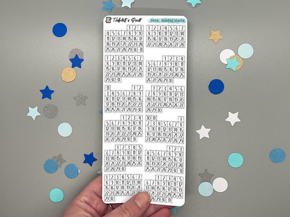 Sheet of pre-printed 2026 Sunday start calendars on a gray background with decorative stars.
