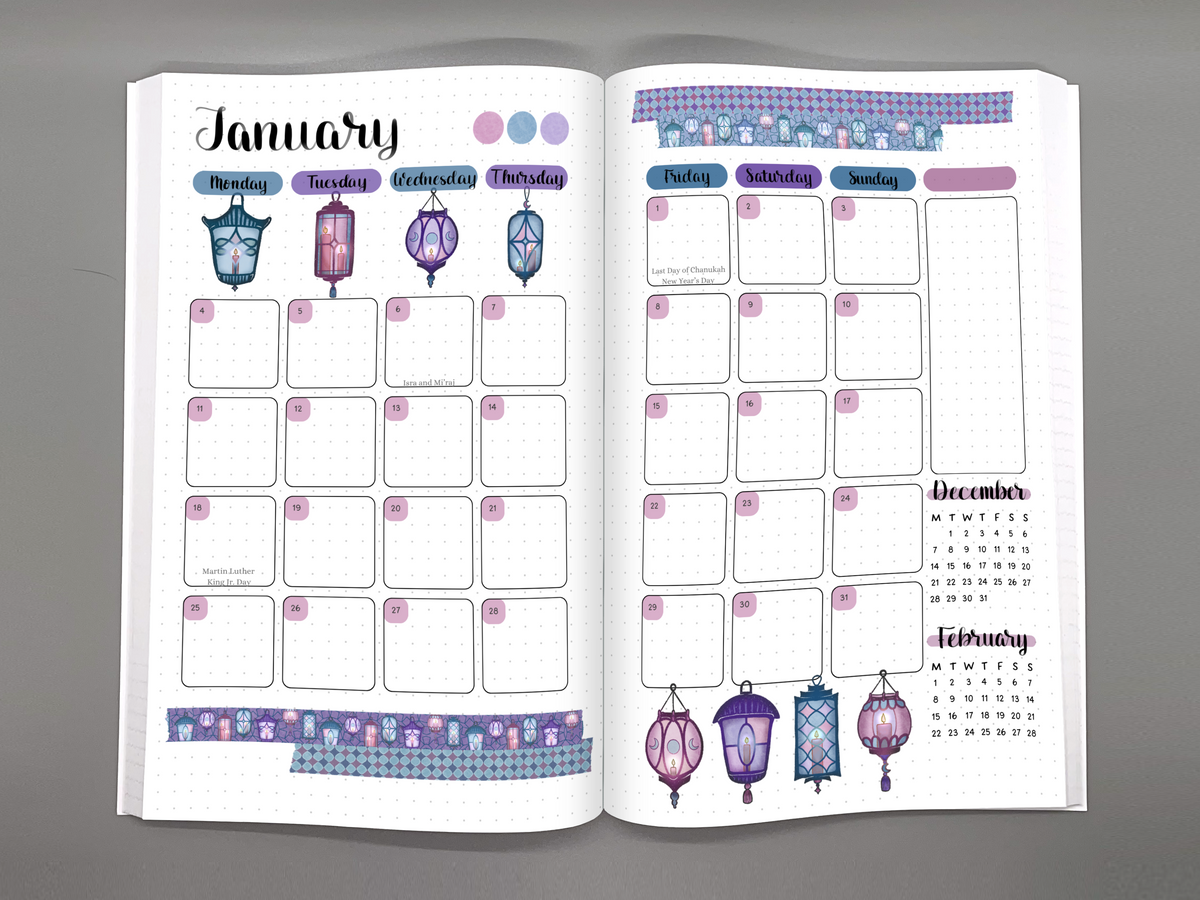 Open 2027 planner on a gray background showing a January monthly calendar page with a lanterns theme.