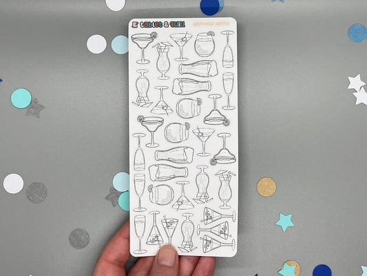 Sticker sheet of diy color drink illustrations held by a hand on a gray background with confetti.