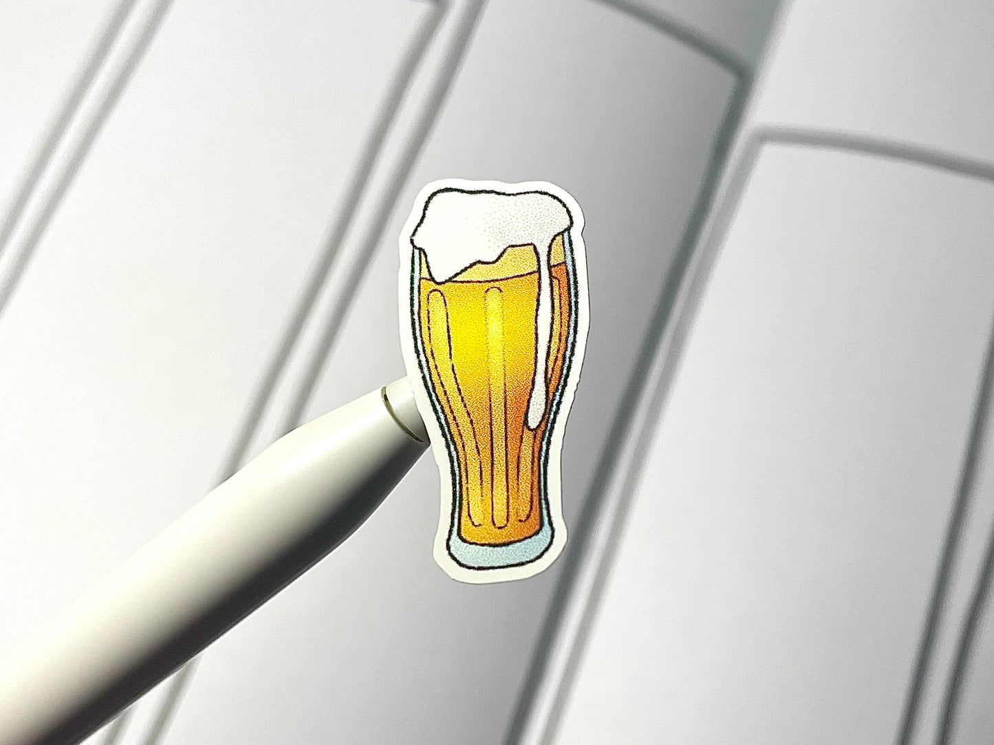 Close up of a cocktail sticker over a journal spread.