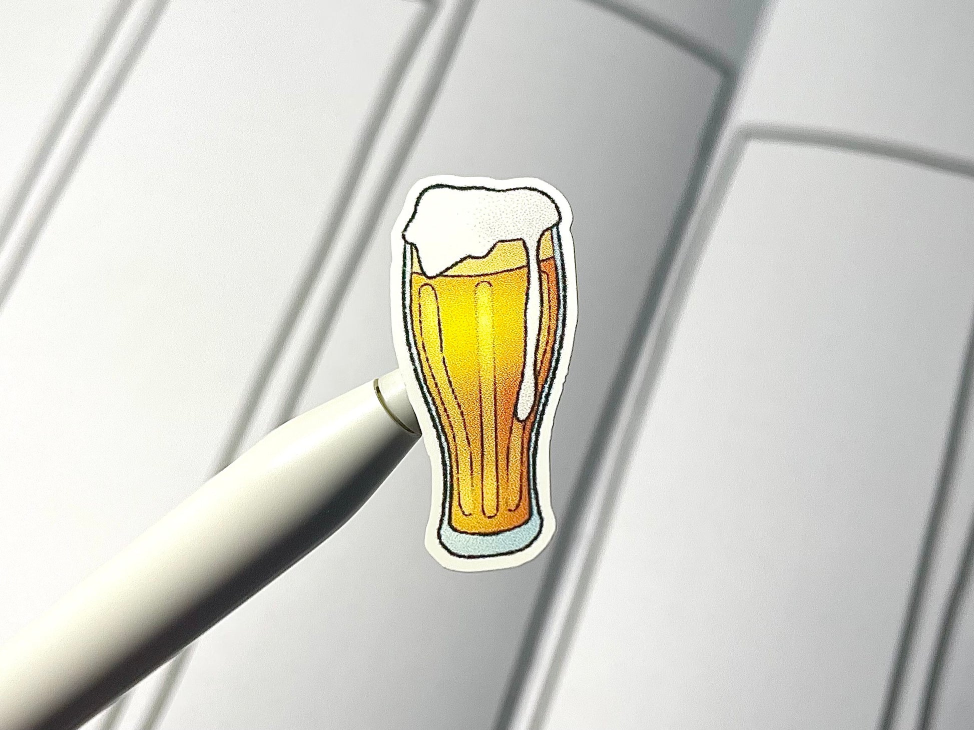 Close up of a cocktail sticker over a journal spread.