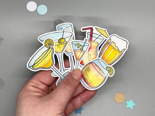 Hand holding stickers of drinks with a gray background
