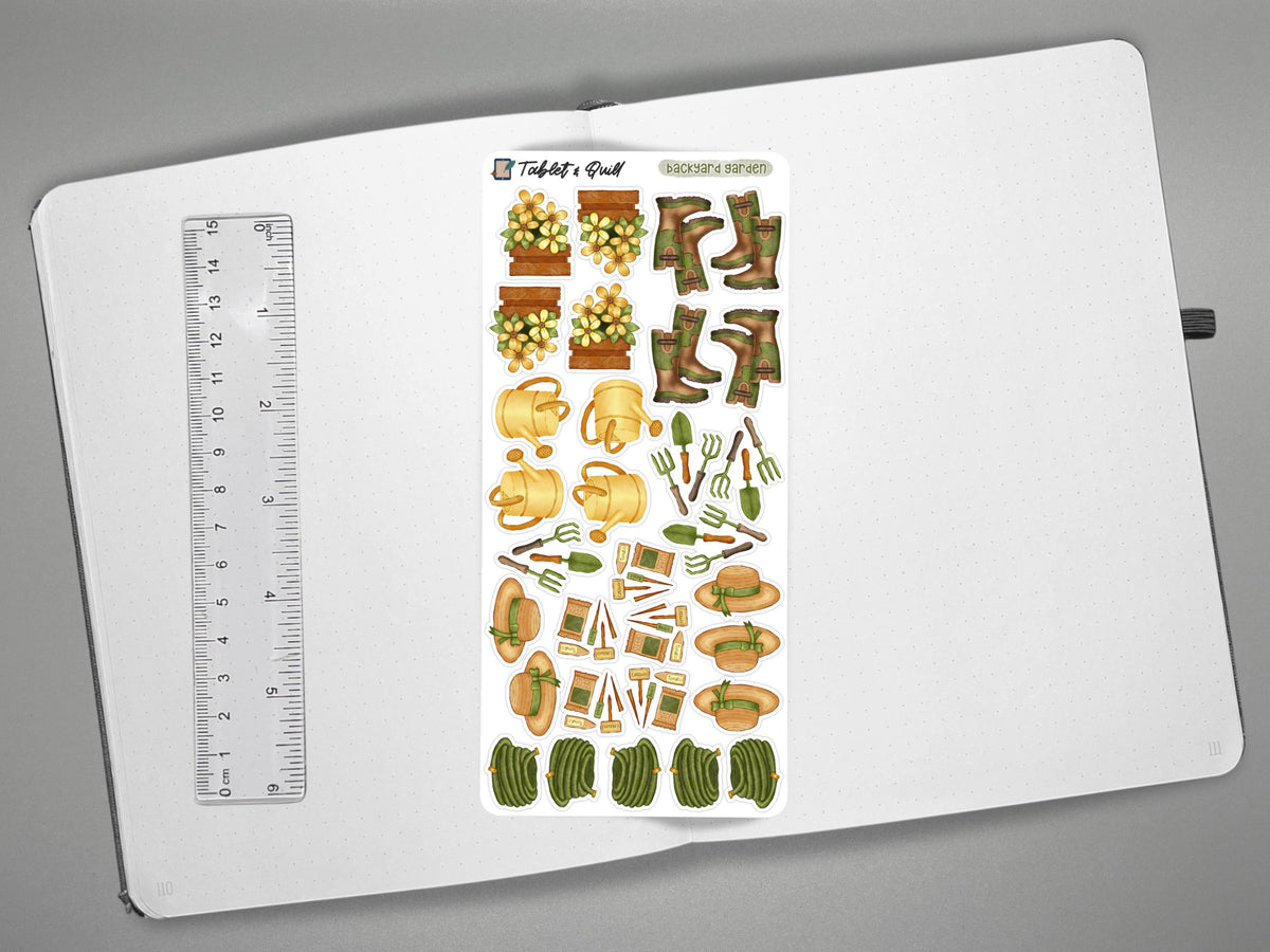 Garden themed sticker sheet on an open journal with a ruler on the left for scale all on a gray surface.