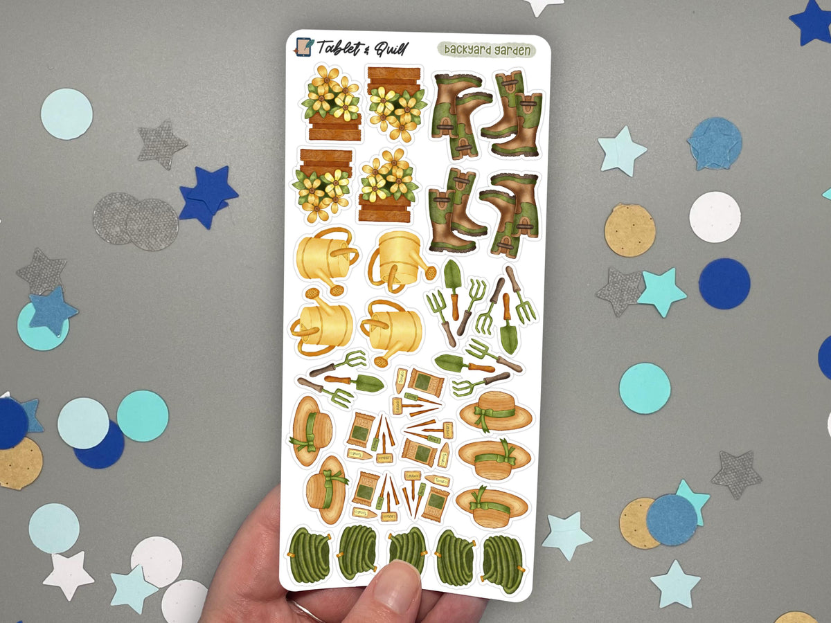 A hand holding a garden themed sticker sheet in color over a gray surface with confetti.
