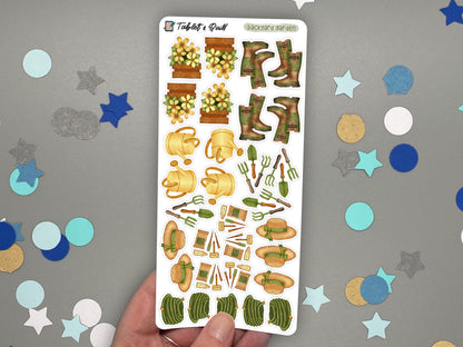 A hand holding a garden themed sticker sheet in color over a gray surface with confetti.