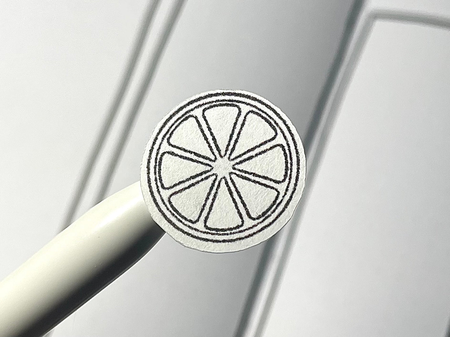 Closeup of a black and white diy color citrus themed sticker over a bullet journal weekly spread.