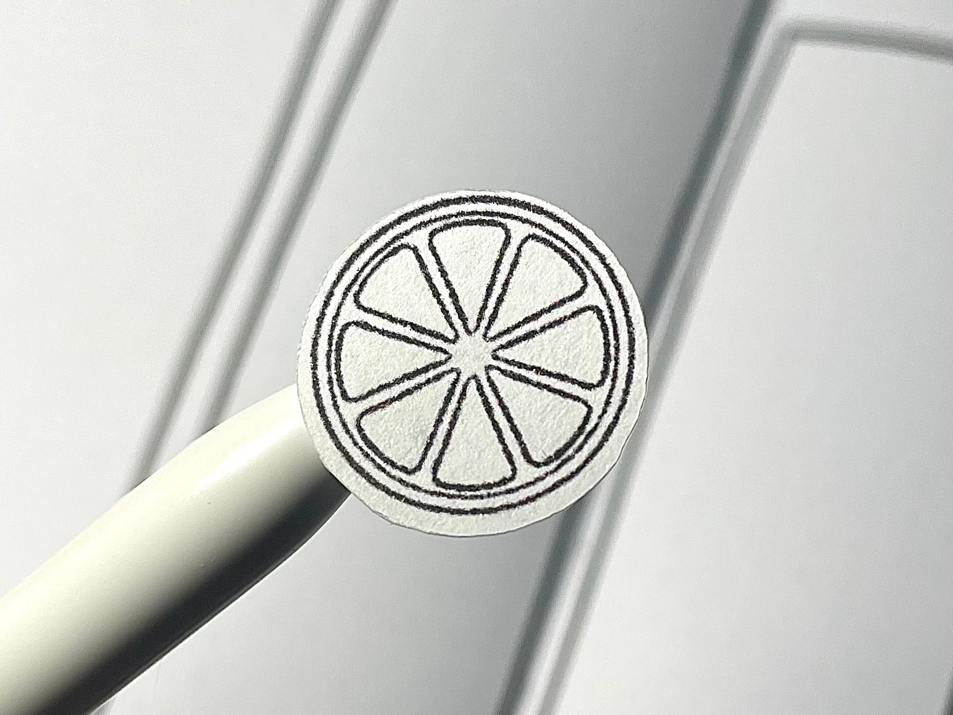 Closeup of a black and white diy color citrus themed sticker over a bullet journal weekly spread.