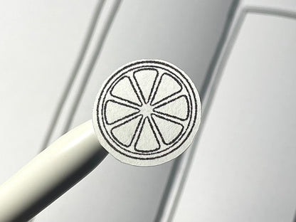 Closeup of a black and white diy color citrus themed sticker over a bullet journal weekly spread.