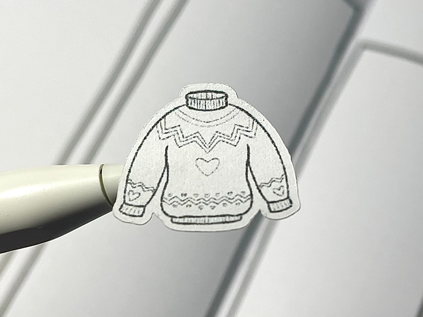 Closeup of DIY color winter clothes themed sticker.