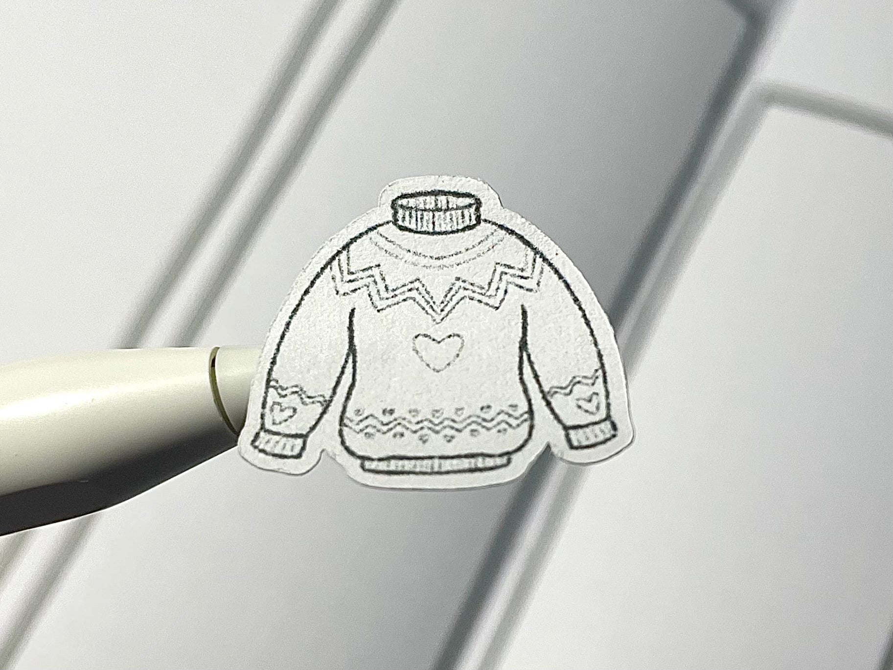 Closeup of DIY color winter clothes themed sticker.