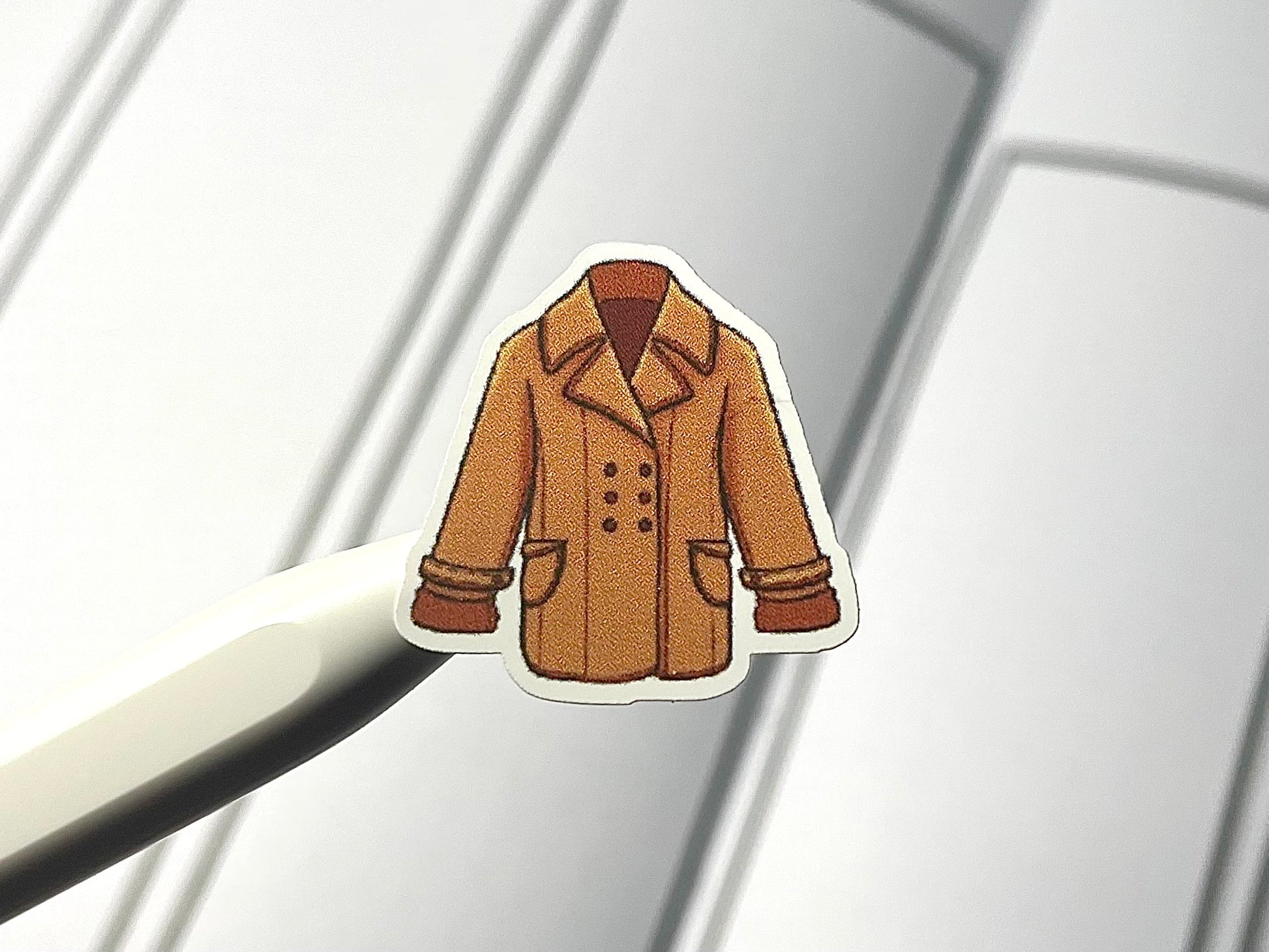 Close up of winter clothes themed sticker in color.