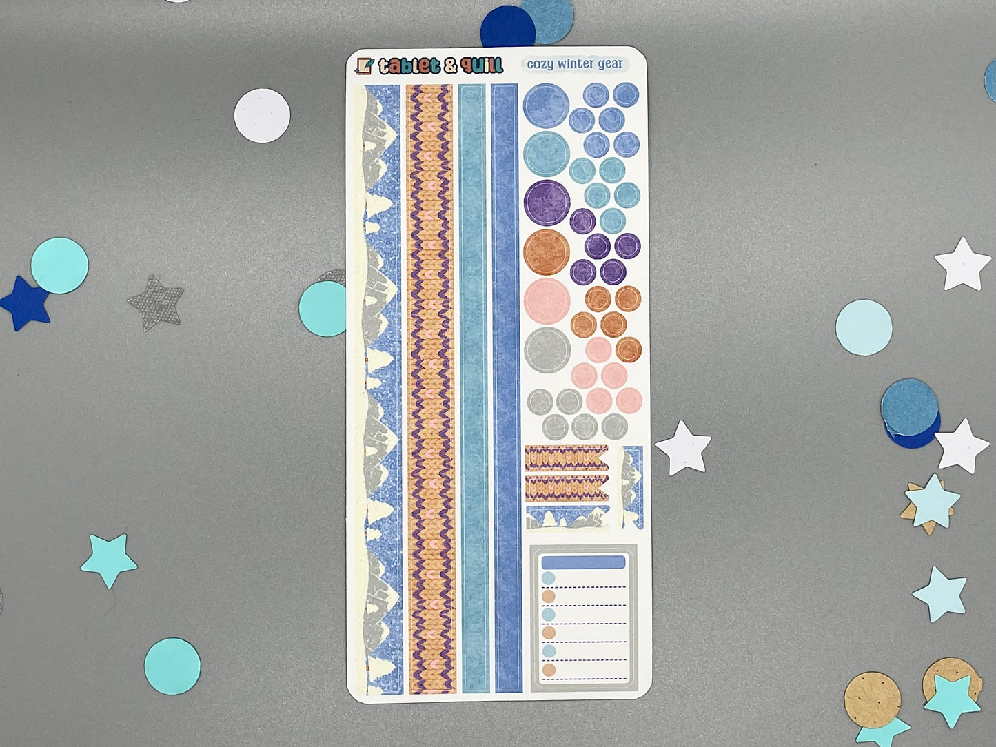 Decorative winter clothes themed sticker sheet on a gray background with confetti.