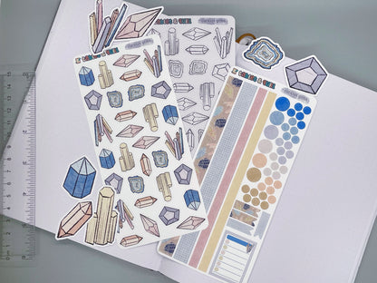 An overview image of crystals themed stickers, including a color sticker sheet, a colorable sticker sheet, a decorative sticker sheet, and die cut sticker flakes. Ruler on the left. 
