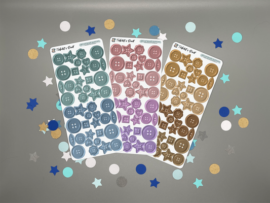 Three sheets of decorative stickers with buttons on a gray background with confetti.