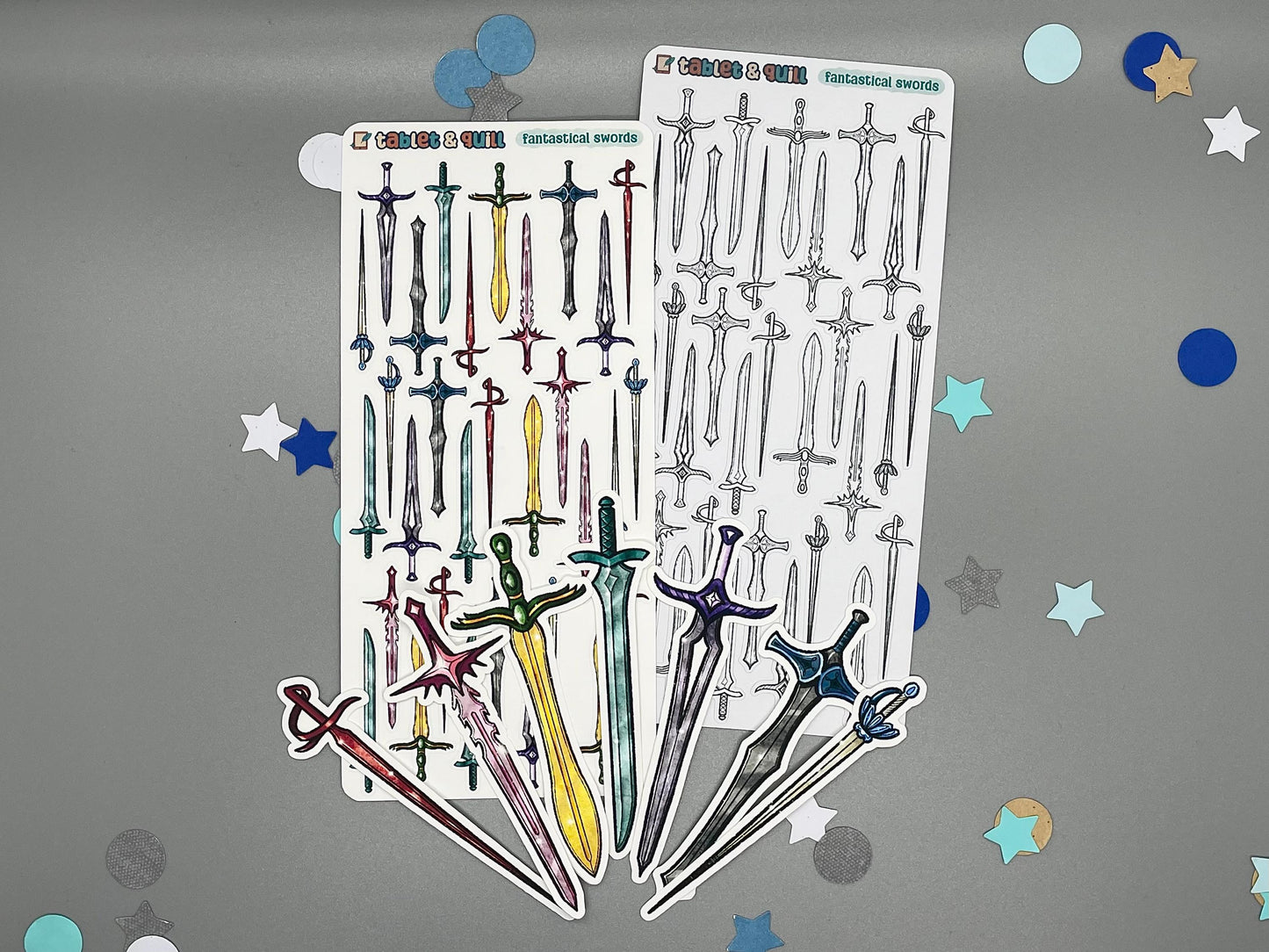 An overview image of swords themed stickers, including a color sticker sheet, a colorable sticker sheet, and die cut sticker flakes.