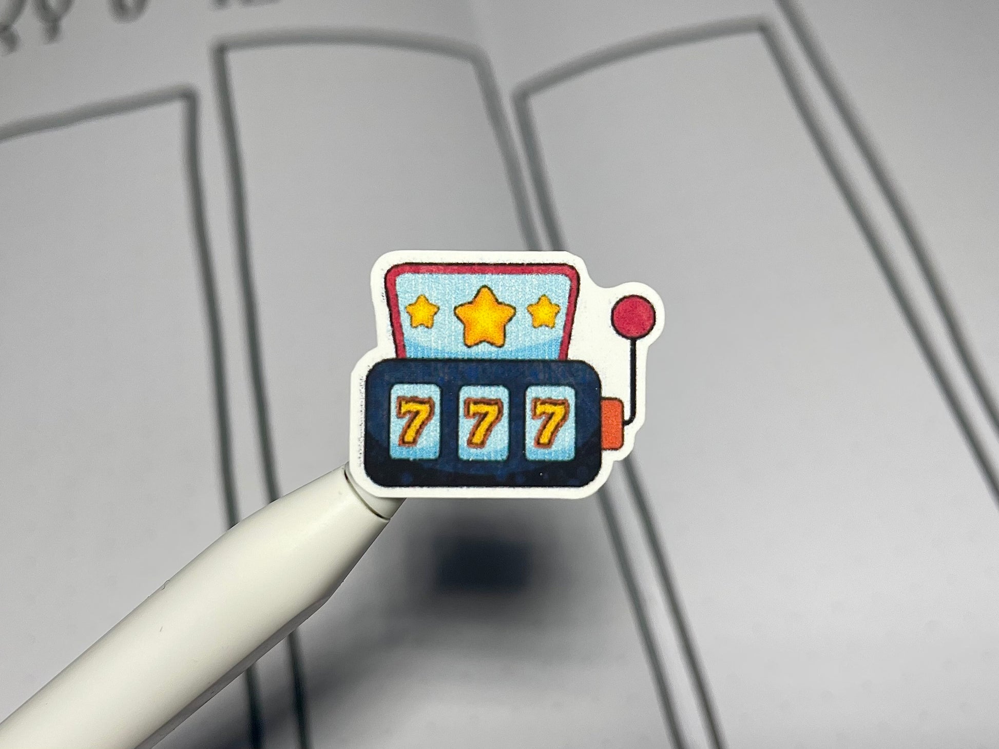 Closeup of a casino themed color sticker with a journal in the background.