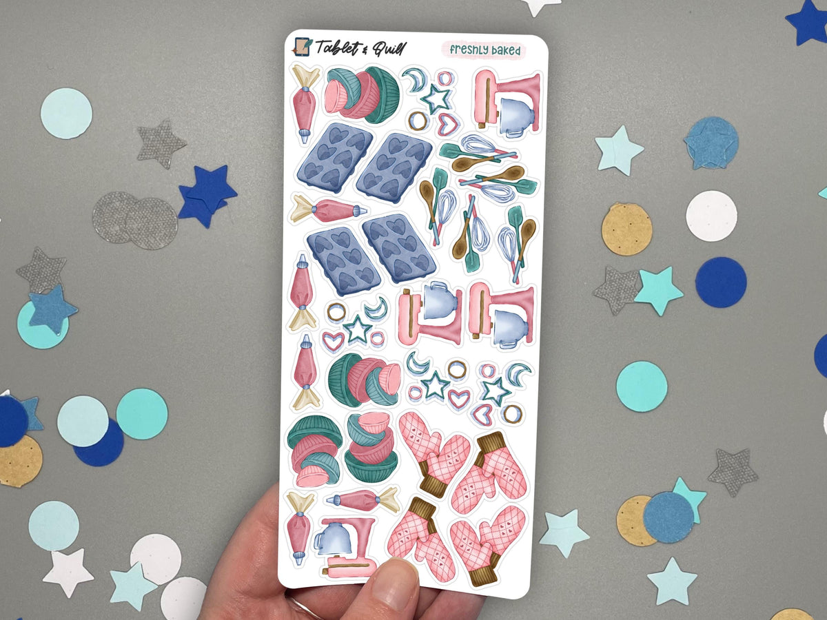 A hand holding a baking themed sticker sheet in color over a gray surface with confetti.