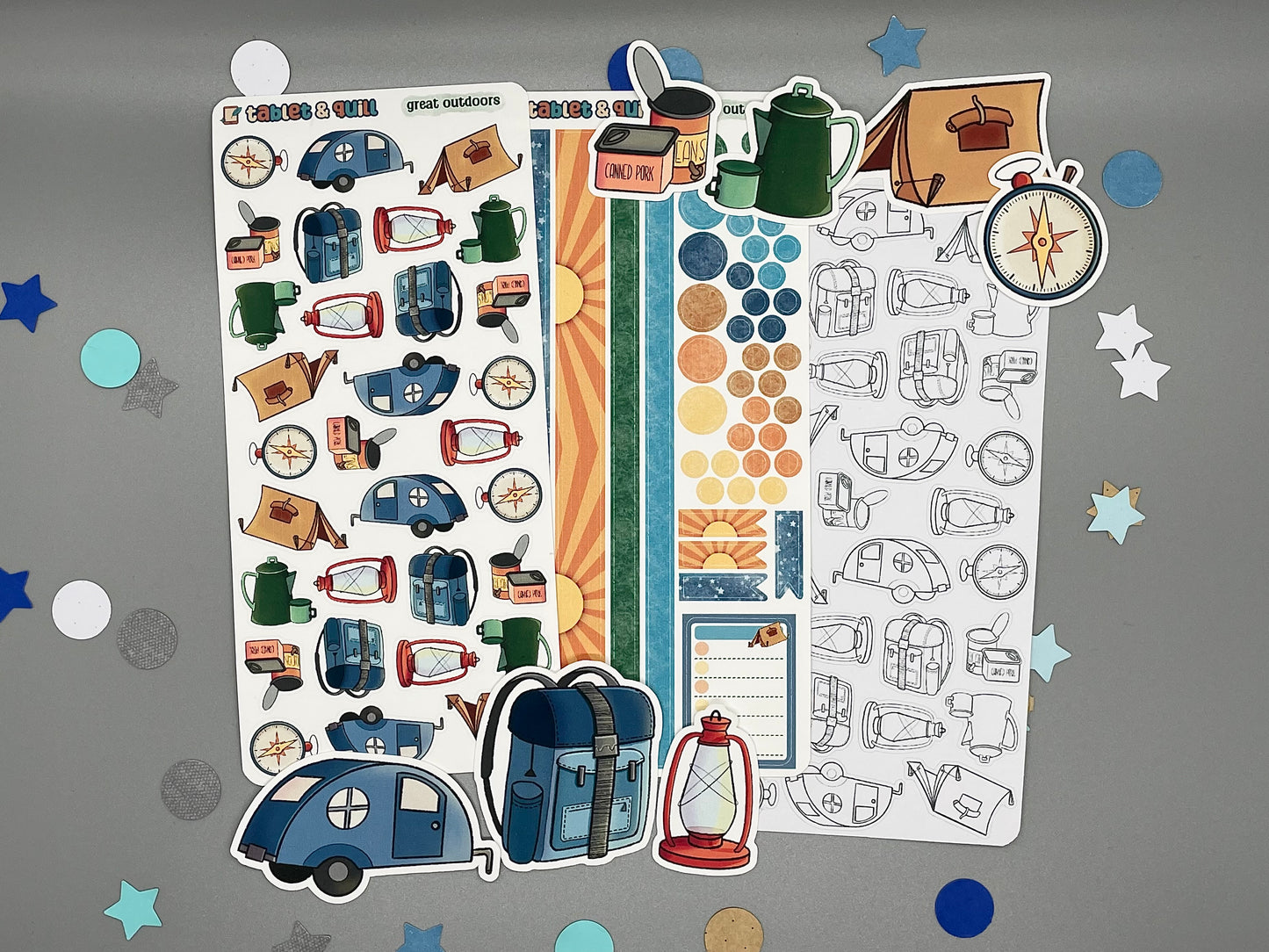 An overview image of camping themed stickers, including a color sticker sheet, a colorable sticker sheet, a decorative sticker sheet, and die cut sticker flakes.