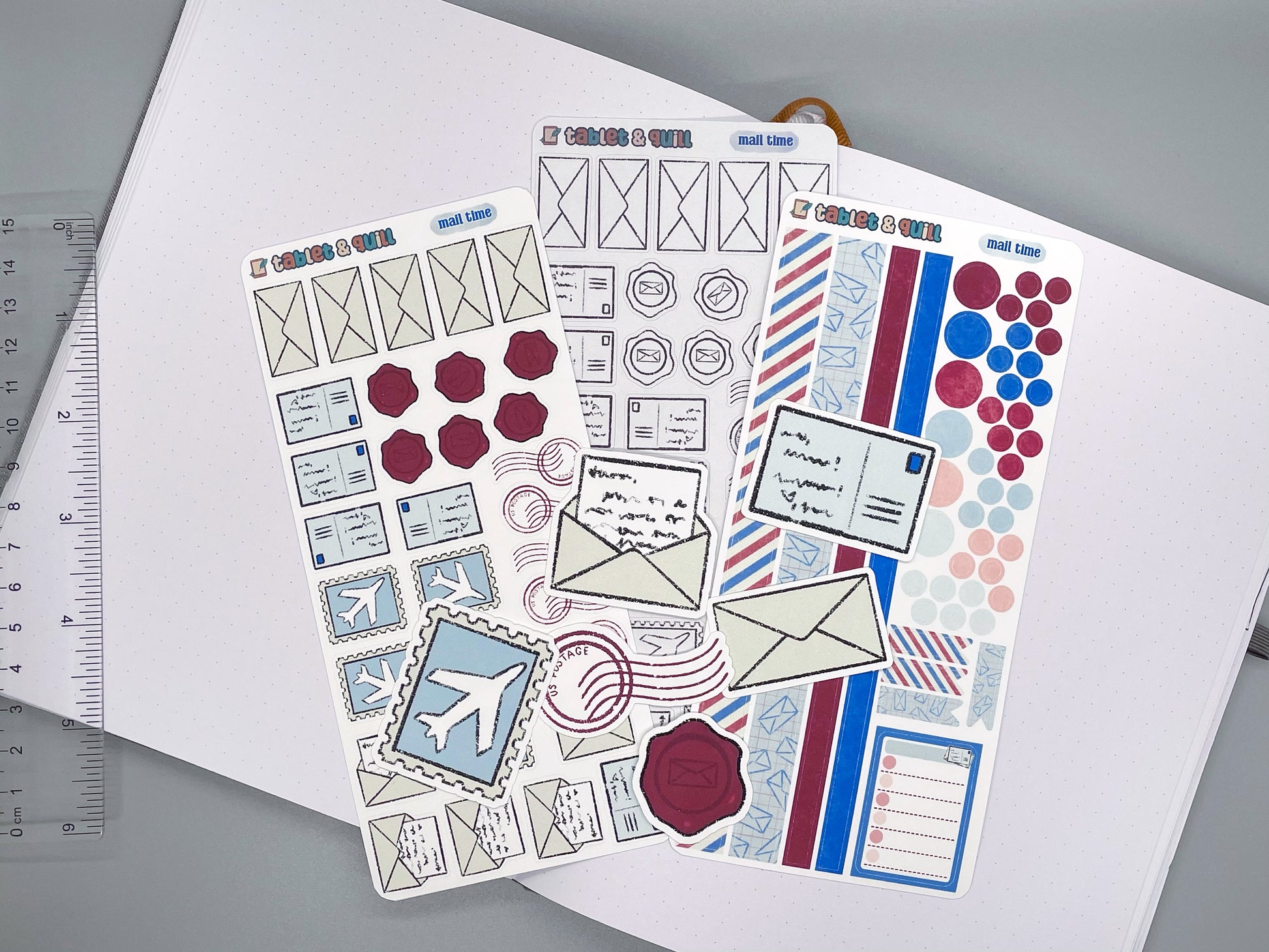 Set of mail themed stickers for bullet journals and planners. Set includes colorable sticker sheet, decorative sticker sheet, color sticker sheet, and die cut sticker flakes. Ruler for scale on the left.