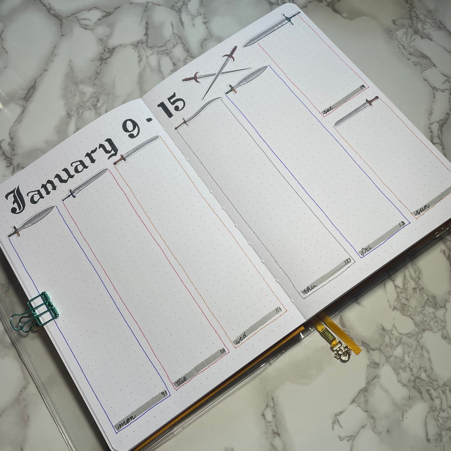 Weekly bullet journal medieval swords themed spread.