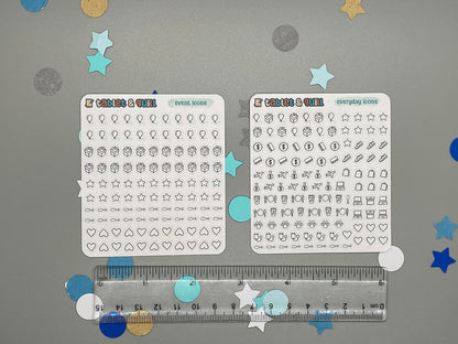Two sheets of stickers with various designs on a gray background with decorative stars and a ruler for scale.