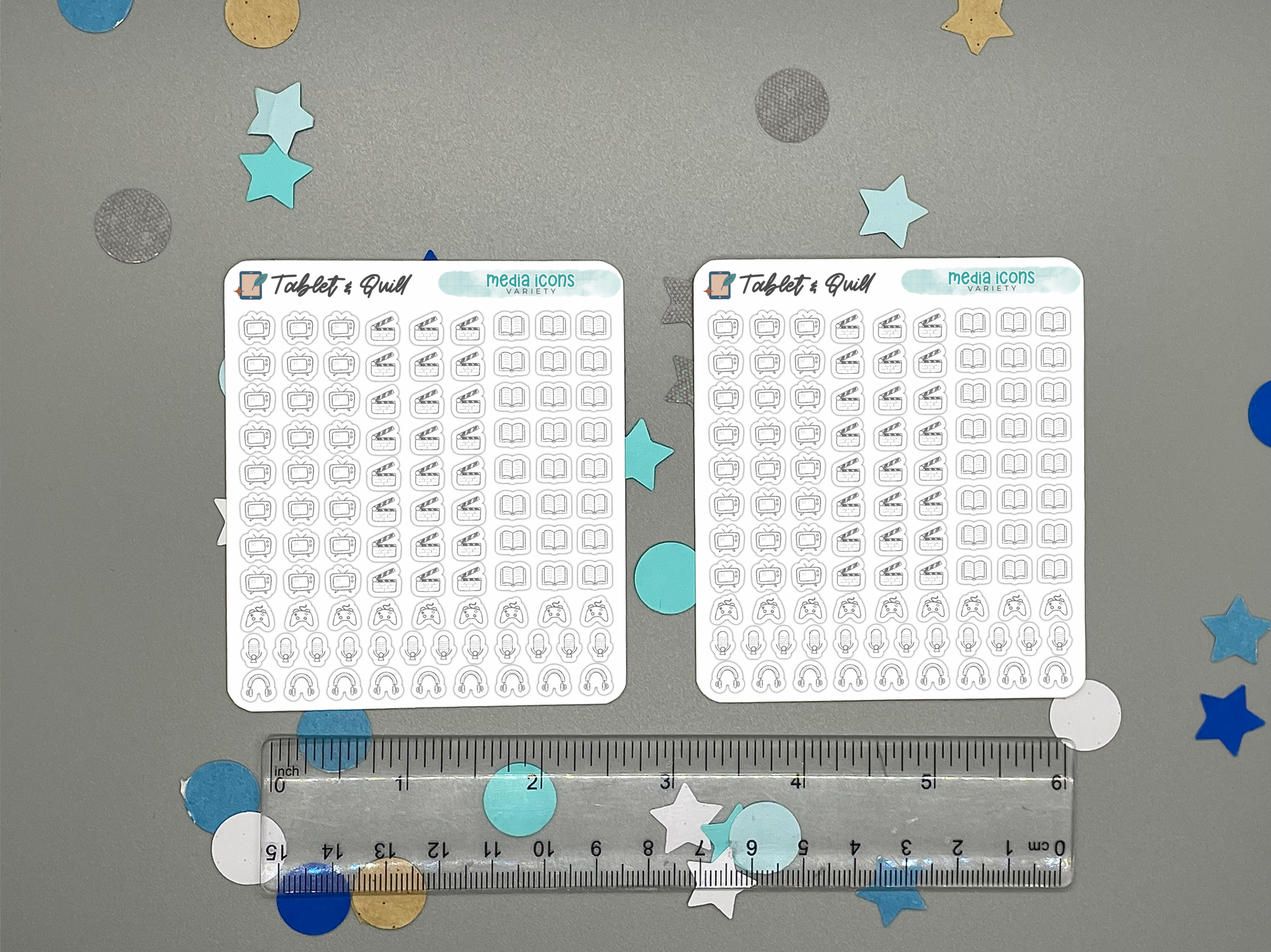 Two sheets of mini planner stickers with various media icons on a gray background with decorative stars and circles with a ruler for scale.