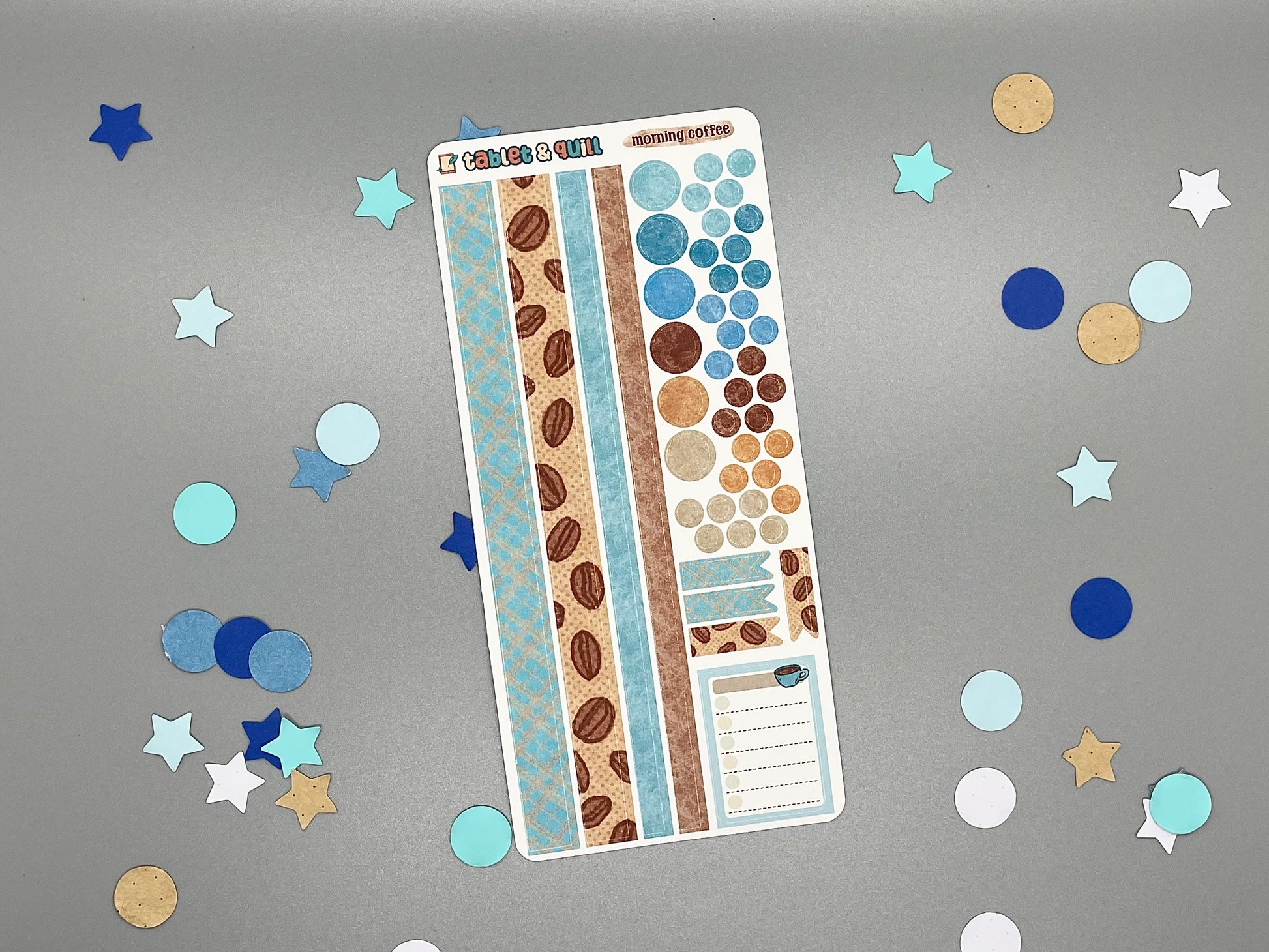 Sticker sheet with matching design as our coffee themed stickers on a gray background with decorative stars and circles.