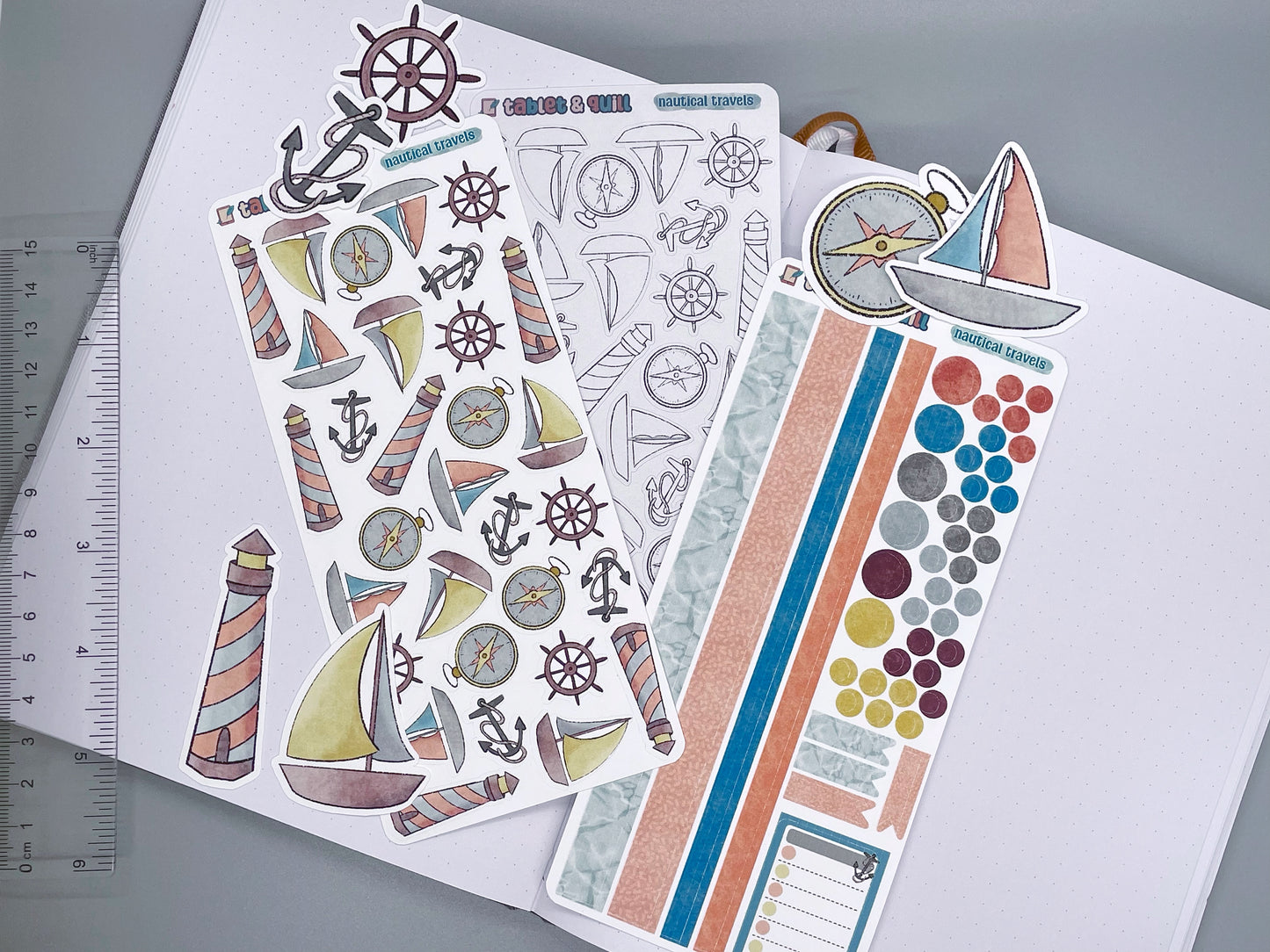 An overview image of nautical stickers, including a color sticker sheet, a colorable sticker sheet, a decorative sticker sheet, and die cut sticker flakes. Ruler on the left. 