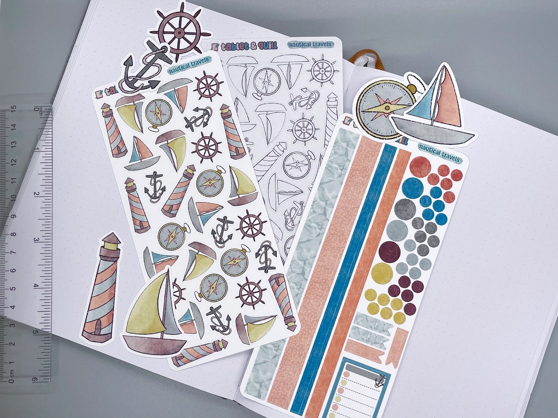 An overview image of nautical stickers, including a color sticker sheet, a colorable sticker sheet, a decorative sticker sheet, and die cut sticker flakes. Ruler on the left. 