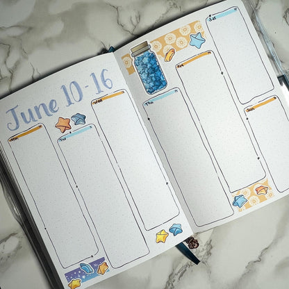 An overview image of a paper stars themed bullet journal weekly spread.
