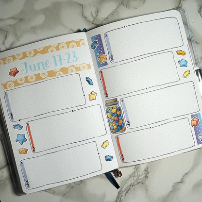 An overview image of a paper stars themed bullet journal weekly spread.