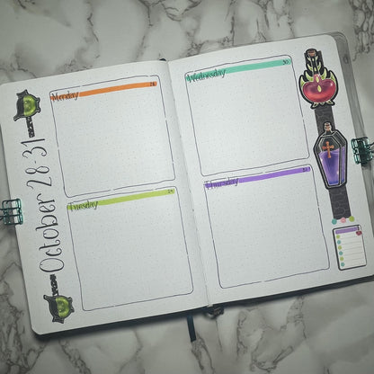 Overview of a bullet journal weekly spread themed with poisonous potions and weekday stickers.