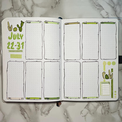 Overview of a cacti themed bullet journal weekly spread.