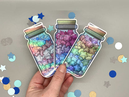 Holographic laminated pride stickers. Paper stars in a jar. Rainbow, bisexual, transgender flag colors.