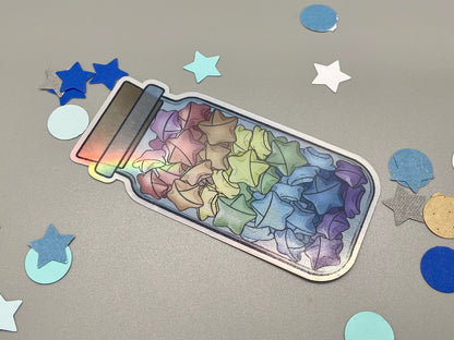 Holographic laminated pride stickers. Paper stars in a jar. Rainbow flag colors.