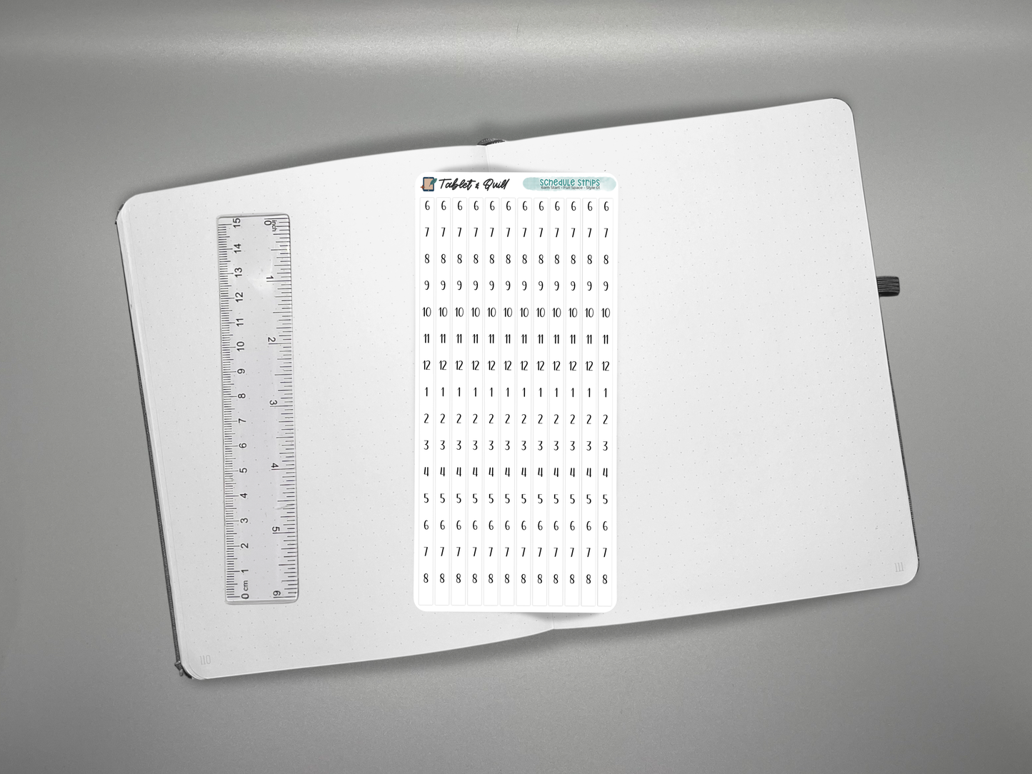 Schedule time blocking sticker sheet on a journal with a ruler for scale over a gray background.