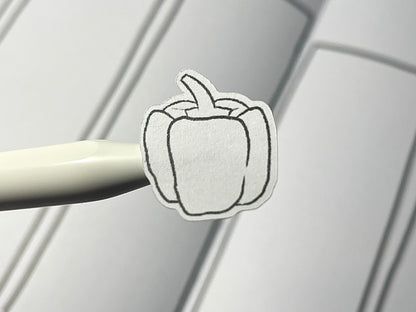 Closeup of pepper themed DIY color sticker over a weekly bullet journal spread.