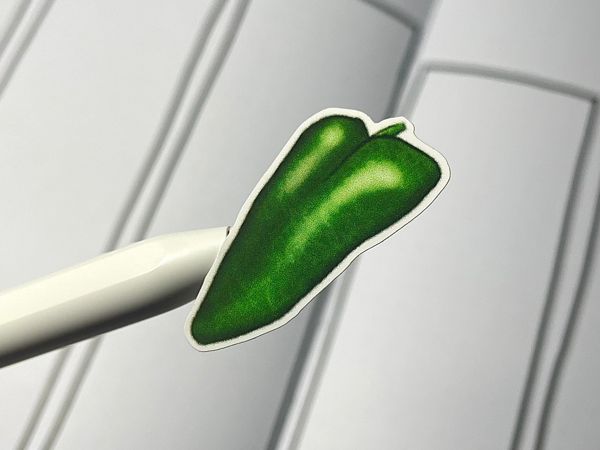 Closeup of a pepper themed sticker over a bullet journal weekly spread.