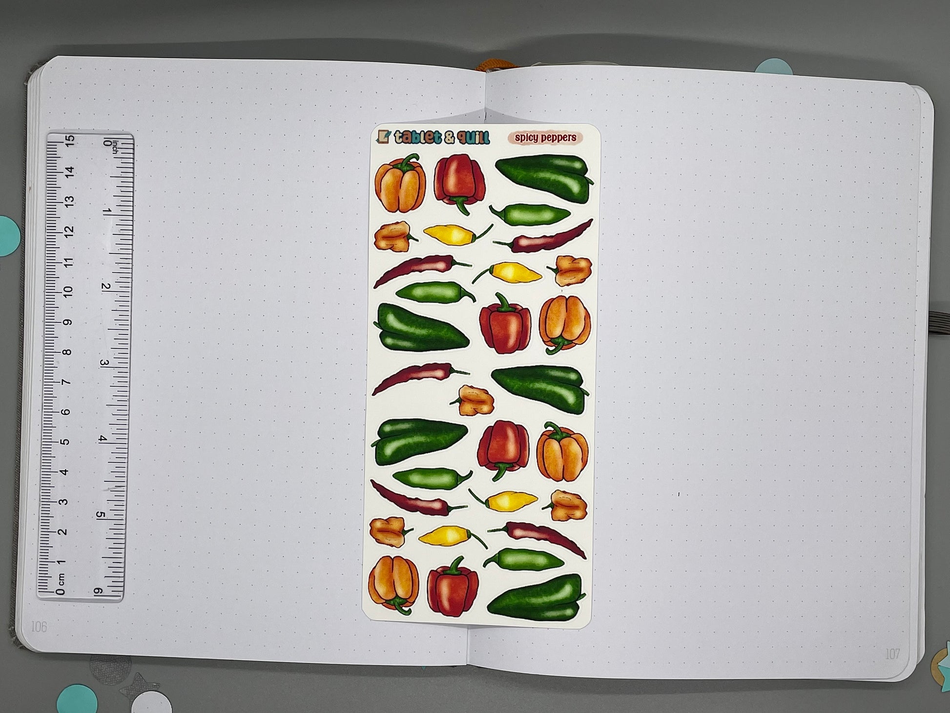 Sheet of pepper stickers on a journal page with a ruler for scale.