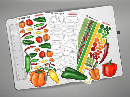 Set of pepper-themed stickers on a journal with a ruler for scale, on a gray background.