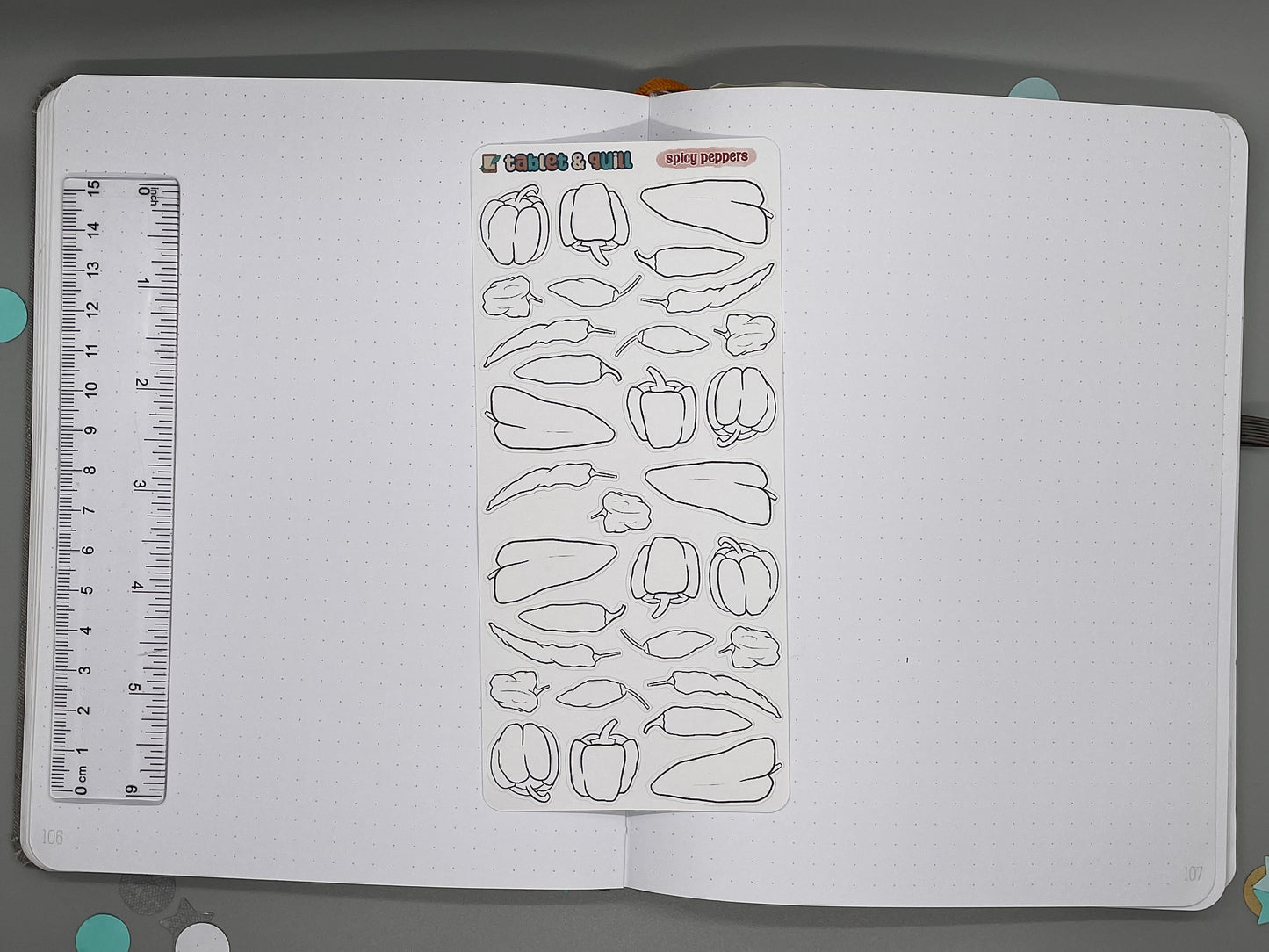 Sheet of diy color pepper stickers in a notebook with a ruler for scale.