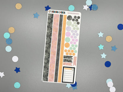 Sticker sheet with matching design as our ghost themed stickers on a gray background with decorative stars and circles.