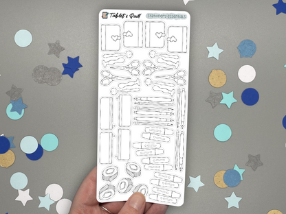 Stationery themed DIY color bullet journal stickers held by a hand and over a gray background with confetti. 