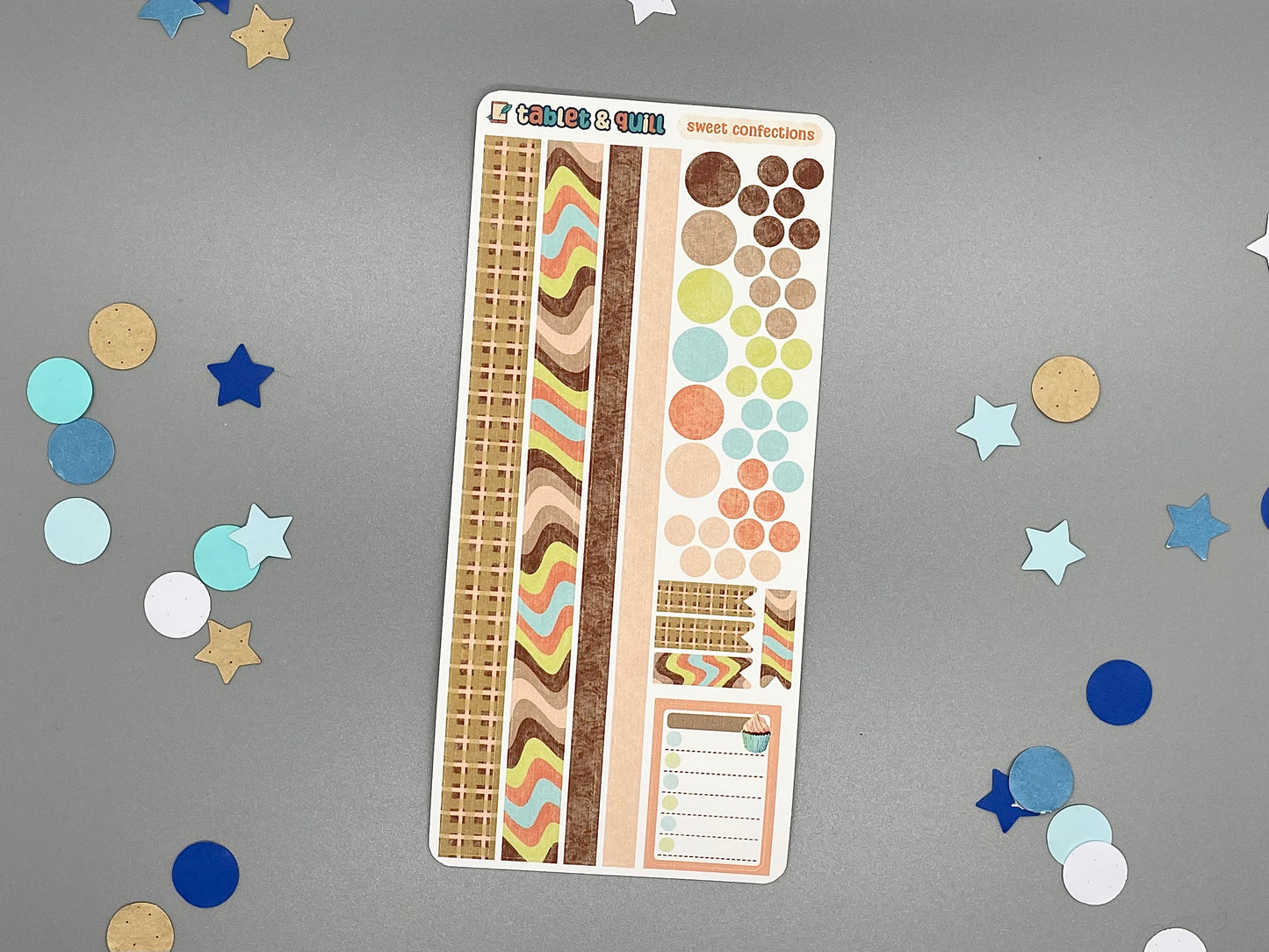 Sticker sheet with various designs on a gray background with decorative confetti.